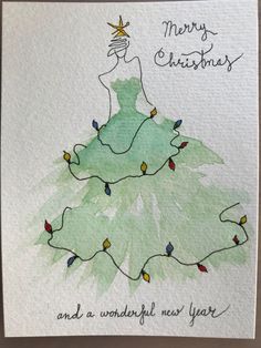 a handmade christmas card with a green dress and lights on the bottom, which reads merry christmas and a wonderful new year