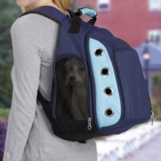 a woman carrying a backpack with a dog in it's back pocket and two holes on the side