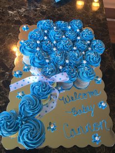 blue cupcakes are arranged in the shape of a bouquet for a baby shower