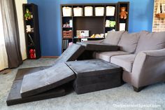 a living room filled with furniture and a book shelf full of books on top of it