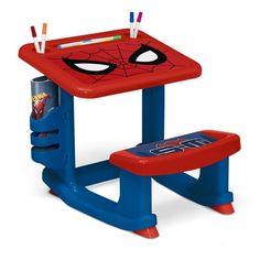 a spiderman desk and chair with markers on the top, next to pencils