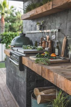 an outdoor kitchen with lots of cooking utensils on the counter and shelves above it