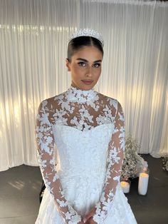 a woman in a white wedding dress posing for the camera