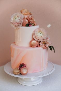 a three tiered cake with pink flowers on top