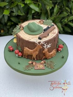 a cake with deer and trees on it