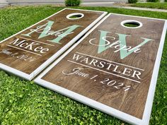 two personalized cornhole game boards on the grass