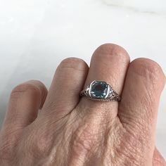 Details: Beautiful Edwardian Aquamarine 18K white gold filigree ring. This ring is very sweet, with delicately detailed filigree with tiny French fleur-de-lis . The aquamarine measures 7.3mm round. The ring is stamped 18K on the inside of the band. Measurements: Ring measures a size 6 1/2 US. It can be re-sized for a fee. Condition: The overall all condition of this ring is very good. Please ask all questions prior to placing an order. Elegant Platinum Topaz Gemstone Ring, Elegant Sterling Silver Birthstone Ring With Rose Cut Diamonds, Elegant Blue Topaz Rings With Rose Cut Diamonds, Elegant Platinum Topaz Ring, Exquisite White Gold Ring With Blue Topaz, Exquisite White Gold Topaz Ring For Anniversary, Exquisite White Gold Rings With Blue Topaz, Elegant White Gold Filigree Ring With Center Stone, Elegant White Gold Topaz Gemstone Ring