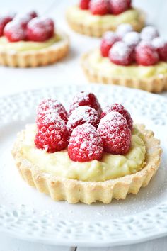 raspberry and vanilla bean cream tarts on a white plate with text overlay