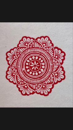 a red and white paper with an intricate design on it