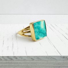 Turquoise Ring | Gold and Silver | Square Gemstone Ring | Triple Band | Statement Ring | Adjustable Ring | Gift for Her Elevate your look with our statement ring, featuring a square-shaped turquoise and a triple band. * Turquoise * Gold/Silver plated brass * Adjustable . . . . . . . . . . . . . . . .   💎 MATERIALS We use high quality chains, stones and materials. If you have any questions about stone or component colors, please don't hesitate to contact us. . . . . . . . . . . . . . . . . . . . . . . . . . . . . . . . . .  📦 PRODUCTION & SHIPPING All pieces are made by Tracy in her studio in sunny Northern California, so please allow 2-3 days before your order is ready to be shipped. Keep in mind that production time does not include shipping time.  Shipping time depends on the shipping Turquoise Ring Gold, Triple Band Ring, Long Statement Earrings, Turquoise Gold Ring, Gold Gemstone Ring, Ringe Gold, Gems Jewelry, Jewelry Case, Ring Gold