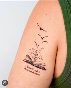 a woman with a book tattoo on her arm and the words i have lived a thousand lives