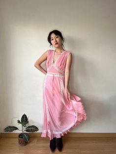 Vintage retro 1930s lace silk ribboned peach pink slip maxi dress material: pure silk chiffon Size: around S,M,Model wears size S, 36 shoulder:38cm pit to pit: 42cm waist:34cm Full length 130cm condition: good antique condition Please keep in mind that this is almost 100 years old. It may have small marks and/or snags and sign of wear throughout. Please purchase willing to accept all signs of wear. ---IMPORTANT NOTE--- PLEASE PROVIDE CONTACT NUMBER UPON CHECKOUT  For shop updates and extra info Luxury Pink Lace Trim Slip Dress, Vintage Silk Slip Dress With Lace Trim, Pink Camisole, Vintage Pink Slip Dress With Lace Trim, Pink V-neck Nightgown With Lace Trim, Vintage Sheer Pink Nightgown, Dress Cottagecore, Lace Silk, Maxi Gown Dress