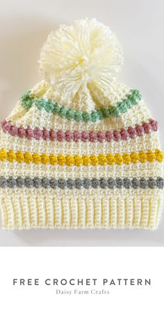 a crocheted hat with a pom - pom on top and the words free