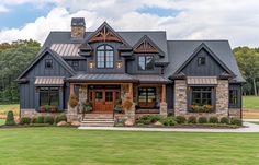 a large house with stone and wood accents