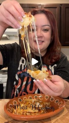 a woman is eating some food from a plate