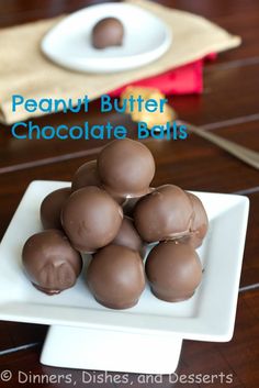 a white plate topped with chocolate balls on top of a wooden table