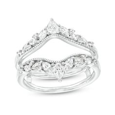 a white gold ring set with three pear shaped diamonds on each band and an intricate design