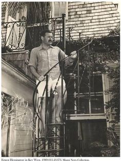 an old photo of a man standing at the top of stairs