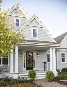 a gray house with white trim and windows