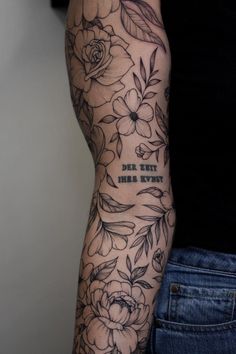 a woman's arm with flowers on it