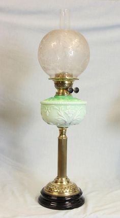 an old fashioned lamp with a glass ball on top