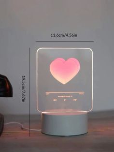 a heart shaped light on top of a table