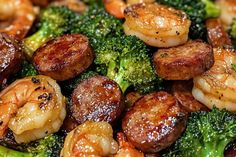 shrimp, broccoli and sausage on a plate with seasoning sprinkles