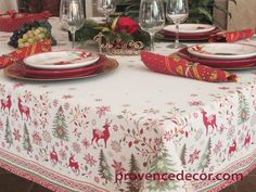 the table is set for christmas dinner with place settings