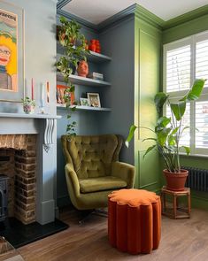 a living room filled with furniture and a fire place in front of a painting on the wall