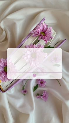 a book with pink flowers sitting on top of it