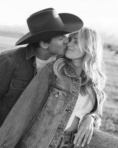 a man in a cowboy hat kissing a woman