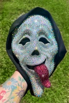 a person wearing a mask with their tongue sticking out