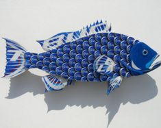 a blue and white fish made out of cans