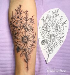 a black and white flower tattoo on the right leg, next to a drawing of flowers