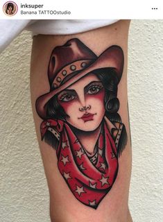 a woman with a cowboy hat and scarf on her leg is shown in this tattoo