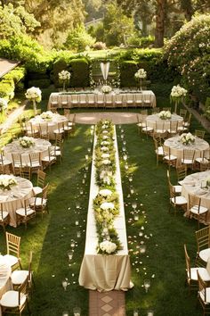 an outdoor wedding setup with white flowers and greenery