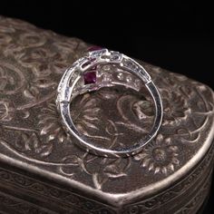 Gorgeous Antique Art Deco Platinum Diamond and French Cut Ruby Ring. A beautiful Art Deco ring finely made and features 4 large French cut rubies going down the center. The ring is also numbered. Item #R0762 Metal: Platinum Diamonds: Approximately 1 cts Ruby: Approximately .80 cts French Cut Weight: 5.1 Grams Size: 5 1/4 Measurements: 12.1 mm long and 5 mm off the finger. Layaway: For your convenience, we will be happy to provide layaway payment options. Please contact us to work out a layaway p Luxury Ruby Marquise Cut Rings, Luxury Ruby Ring With Diamond Accents And Round Shape, Luxury Round Ruby Ring With Diamond Accents, Luxury Ruby Ring With Multi-stone Round Cut, Luxury Round Cut Multi-stone Ruby Ring, Luxury Ruby Rings With Diamond Accents, Luxury Multi-stone Round Cut Ruby Ring, Luxury Ruby Ring Marquise Cut For Formal Events, Luxury Marquise Cut Ruby Ring For Formal Occasions