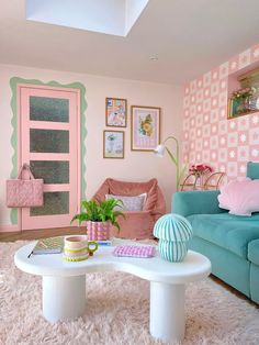 a living room filled with furniture and pink walls