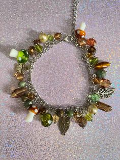 Add a touch of nature to your dream aesthetic with this mushroom charm bracelet! With earthy colors and elements such as green & brown mushrooms, a leaf, an owl, a clover, this charm bracelet will never fade from its original colors. Check out our charm bracelets section for more unique designs! Product info: *Made with stainless steel materials only (except charms that are regular metal) *Adjustable, reaches up to 6.5 inches *Charm materials consist of metal and glass If you have any questions, please don't hesitate to ask! We are friendly:) Visit our official website: www.yeetincolorboutique.com and follow us on Instagram: @yeetincolorboutique Gremlin Core, Shifting Wardrobe, Dr Belongings, Fairy Things, Cottagecore Jewelry, Mushroom Jewelry, Dream Aesthetic, Spend Money, Fame Dr