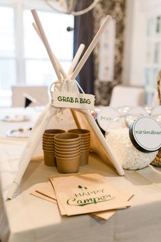 a table set up for a party with plates, cups and napkins on it