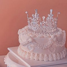 a white wedding cake with a tiara on top