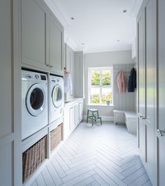 a washer and dryer in a white laundry room