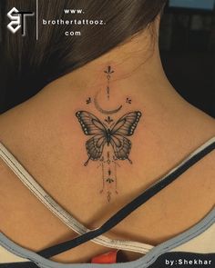 a woman's back neck with a butterfly tattoo on the upper part of her chest