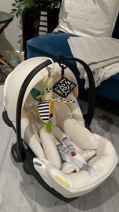 a baby's car seat in the middle of a living room