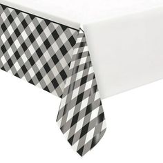 a black and white checkered tablecloth with a tie on it