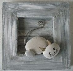 a stuffed animal in a wooden frame with a hook on it's side and a string attached to the wall