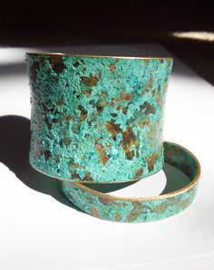 a close up of a metal object on a white surface with sunlight coming through it