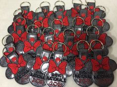 a bunch of red and silver mickey mouse key chains