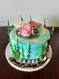 a birthday cake decorated with an image of a fish in the water and flowers on top