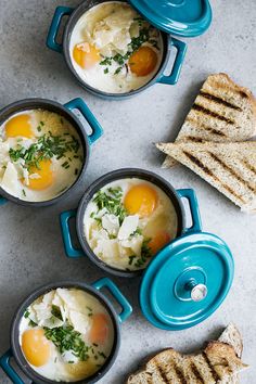 eggs and toast in blue pots on a table